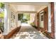 Carport featuring white brick columns and trellises, with a view of the landscaped driveway and charming white picket fence at 3448 Paces Ferry Cir, Smyrna, GA 30080