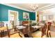 Well-decorated dining room featuring teal walls, wood floors, and an open-concept design at 3448 Paces Ferry Cir, Smyrna, GA 30080