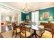 Chandelier illuminates a teal dining room complete with antique furnishings at 3448 Paces Ferry Cir, Smyrna, GA 30080