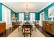 Dining room featuring teal walls, wood floors, and wainscoting at 3448 Paces Ferry Cir, Smyrna, GA 30080