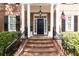 Brick entry with black door and railing at 3448 Paces Ferry Cir, Smyrna, GA 30080