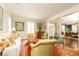 Bright living room featuring a white couch, eclectic furnishings, and an open layout that seamlessly connects to the dining area at 3448 Paces Ferry Cir, Smyrna, GA 30080