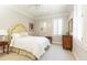 Serene bedroom featuring a bed with a quilted coverlet and a window with shutters at 3448 Paces Ferry Cir, Smyrna, GA 30080