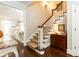 Beautiful staircase with hardwood floors, white railings, and a glimpse of the living room at 3448 Paces Ferry Cir, Smyrna, GA 30080