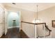 Upstairs hallway features hardwood floors, pendant light, and art at 3448 Paces Ferry Cir, Smyrna, GA 30080