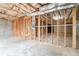 Unfinished basement featuring exposed wooden framing, concrete floor, and insulation at 3502 Crown Peak Ct, Suwanee, GA 30024