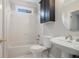 Bathroom featuring a white tiled shower, pedestal sink, and black vanity at 3502 Crown Peak Ct, Suwanee, GA 30024