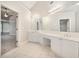 Bright bathroom featuring double vanity sinks and mirrors, tiled floors, and abundant counter space at 3502 Crown Peak Ct, Suwanee, GA 30024