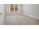 Cozy bedroom featuring neutral carpeting, ample natural light, and a bright neutral color scheme at 3502 Crown Peak Ct, Suwanee, GA 30024