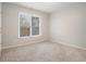 Clean bedroom featuring neutral carpeting, a window, and a bright neutral color scheme at 3502 Crown Peak Ct, Suwanee, GA 30024