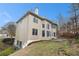 Two-story house featuring neutral siding, a patio, and mature trees at 3502 Crown Peak Ct, Suwanee, GA 30024