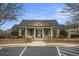 Exterior shot of the clubhouse, featuring a covered entrance and well-maintained landscaping at 4325 Cody Ct, Cumming, GA 30040