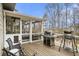 This large outdoor deck features a full outdoor kitchen and screened-in lounge with natural wood flooring at 4325 Cody Ct, Cumming, GA 30040