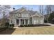 Stately two-story brick home with manicured landscaping, covered entryway and well-maintained lawn at 4325 Cody Ct, Cumming, GA 30040