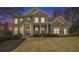 Charming two-story brick home featuring a landscaped yard and covered front porch with stately columns at 4325 Cody Ct, Cumming, GA 30040