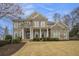 The exterior features a stone facade, a manicured lawn, and a covered entryway at 4325 Cody Ct, Cumming, GA 30040