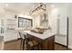 Bright kitchen featuring white cabinets, stainless steel appliances, island with seating, and hardwood floors at 4325 Cody Ct, Cumming, GA 30040