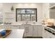 Close-up view of white cabinets, countertops and a large garden window at 4325 Cody Ct, Cumming, GA 30040