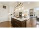 Bright, white kitchen featuring a dark wood island, fireplace view and appliances at 4325 Cody Ct, Cumming, GA 30040