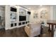 Cozy living room features custom shelving, a stacked stone accent wall, and hardwood floors at 4325 Cody Ct, Cumming, GA 30040