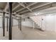 Unfinished basement with painted block walls, black support posts, and stairs to the main level at 442 Mountain Park Trl, Stone Mountain, GA 30087