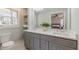 Elegant bathroom featuring dual sinks, gray vanity, and natural light from the window at 442 Mountain Park Trl, Stone Mountain, GA 30087