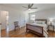 Cozy bedroom with hardwood floors, a ceiling fan, and natural light from the window at 442 Mountain Park Trl, Stone Mountain, GA 30087