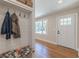 Cozy entryway with a built-in bench and coat rack, hardwood floors, and a white front door at 442 Mountain Park Trl, Stone Mountain, GA 30087