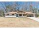 Beautifully renovated home with white brick, wooden columns, new roof, and a bright blue front door for eye-catching curb appeal at 442 Mountain Park Trl, Stone Mountain, GA 30087