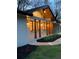 Charming home featuring wooden columns and a freshly painted white brick exterior, complemented by manicured landscaping at 442 Mountain Park Trl, Stone Mountain, GA 30087