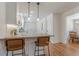 Modern kitchen featuring white cabinets, granite countertops, pendant lighting and stainless steel appliances at 442 Mountain Park Trl, Stone Mountain, GA 30087