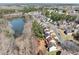 Aerial view of a suburban neighborhood with a pond nearby at 900 Melrose Park Pl, Lawrenceville, GA 30044