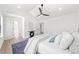 Cozy bedroom with ceiling fan, natural light, and wood-look flooring at 900 Melrose Park Pl, Lawrenceville, GA 30044