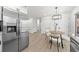 Contemporary dining area adjacent to kitchen, featuring stylish seating and modern finishes at 900 Melrose Park Pl, Lawrenceville, GA 30044