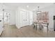 Bright dining area with modern light fixture, white walls, and views out to the deck at 900 Melrose Park Pl, Lawrenceville, GA 30044