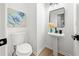 Stylish powder room featuring a pedestal sink, modern fixtures, and attractive wall art at 900 Melrose Park Pl, Lawrenceville, GA 30044