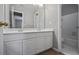 Bathroom featuring double sinks, white cabinets, a large mirror, tile flooring, and a door to a tub and toilet at 1278 Crown Ter, Marietta, GA 30062