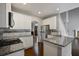 Open kitchen layout with granite countertops, stainless steel appliances and dark wood flooring at 1278 Crown Ter, Marietta, GA 30062