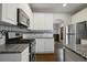 Modern kitchen featuring stainless steel appliances, granite countertops, and white cabinetry at 1278 Crown Ter, Marietta, GA 30062