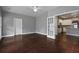 Open living room adjacent to kitchen with hardwood flooring, neutral walls, and view to kitchen at 1278 Crown Ter, Marietta, GA 30062