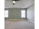 Spacious primary bedroom with neutral walls, tray ceilings, two windows with blinds, and plush carpeting at 1278 Crown Ter, Marietta, GA 30062