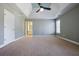 Carpeted primary bedroom features a tray ceiling, an ensuite bathroom, and a large window with natural light at 1278 Crown Ter, Marietta, GA 30062