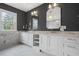 A luxury bathroom featuring double vanity, marble countertops, decorative mirrors and tile at 239 E Wesley Ne Rd, Atlanta, GA 30305