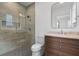 Modern bathroom featuring a tiled shower with glass door and wood vanity with marble countertop at 239 E Wesley Ne Rd, Atlanta, GA 30305