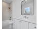 Bathroom featuring vanity, mirror, a window, and a shower/tub at 239 E Wesley Ne Rd, Atlanta, GA 30305