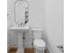 Bright, modern powder room featuring a pedestal sink and minimalist design elements at 239 E Wesley Ne Rd, Atlanta, GA 30305