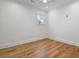 Bedroom with hardwood flooring, neutral paint, white trim, and a single window at 239 E Wesley Ne Rd, Atlanta, GA 30305