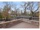 Brick and wood deck with metal railing overlooking the back yard at 239 E Wesley Ne Rd, Atlanta, GA 30305