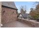Wood deck with brick and stone surround and black metal railing at 239 E Wesley Ne Rd, Atlanta, GA 30305