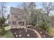 Handsome two-story home with stone accents, a brick chimney, and meticulously landscaped front yard at 239 E Wesley Ne Rd, Atlanta, GA 30305